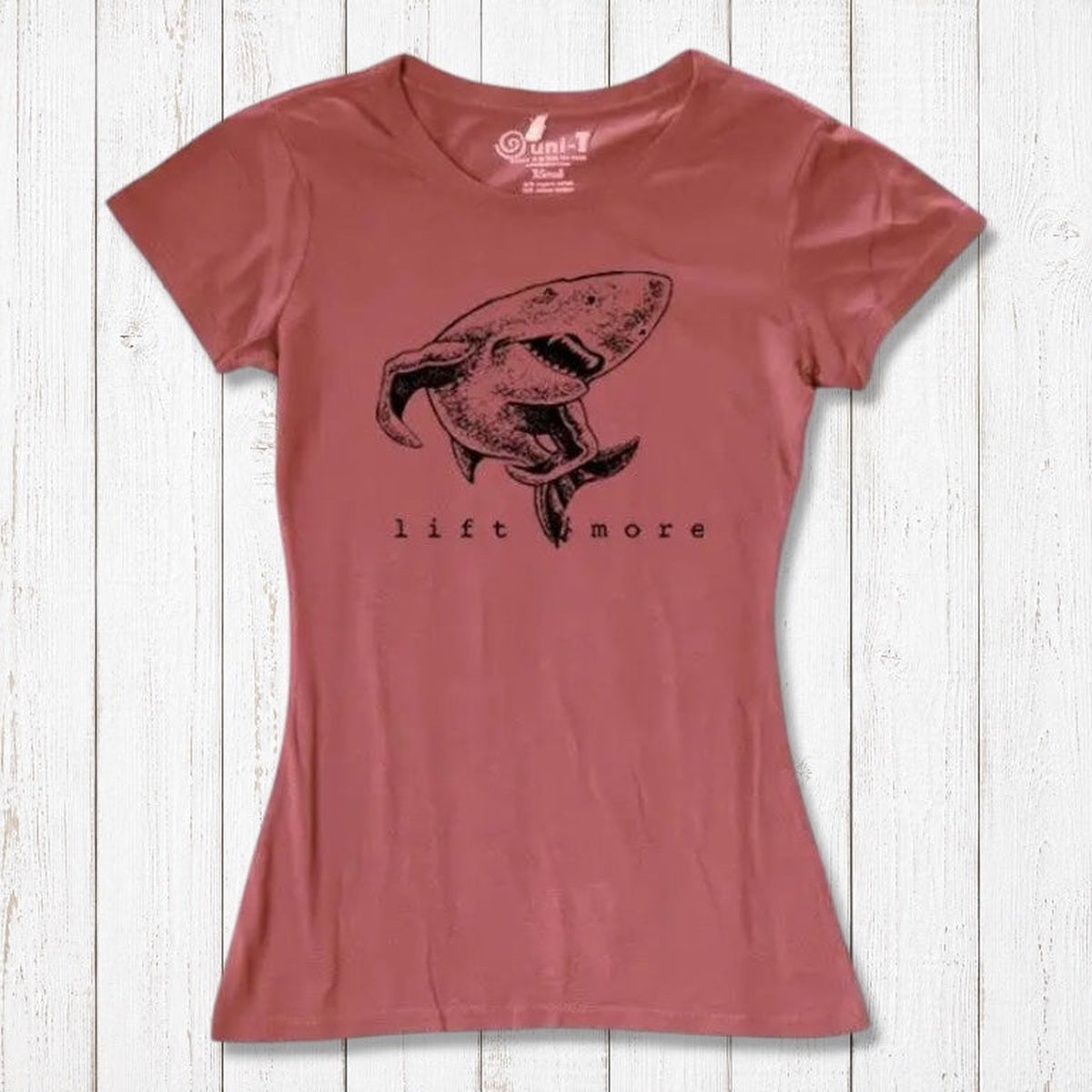 Rust red women's shark T-shirt with 'Lift More' print, crafted from bamboo and organic cotton. Sustainable gym motivation top.