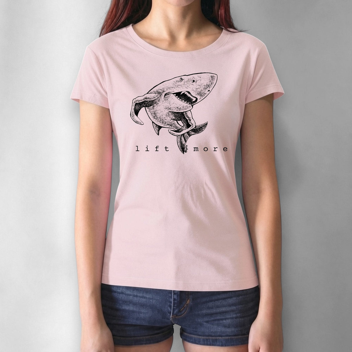 Pink women's workout T-shirt in bamboo and organic cotton with shark 'Lift More' design. Empowering gym wear for women lifters.