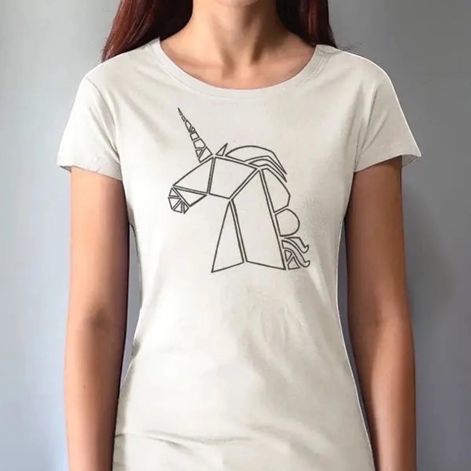 Model wearing cream Women’s Unicorn T-Shirt in bamboo and organic cotton with black geometric unicorn print. Unique eco-friendly gift for fantasy lovers.