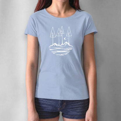 Light blue women's graphic tee with black forest and mountain illustration. Sustainable bamboo and cotton blend for nature enthusiasts.