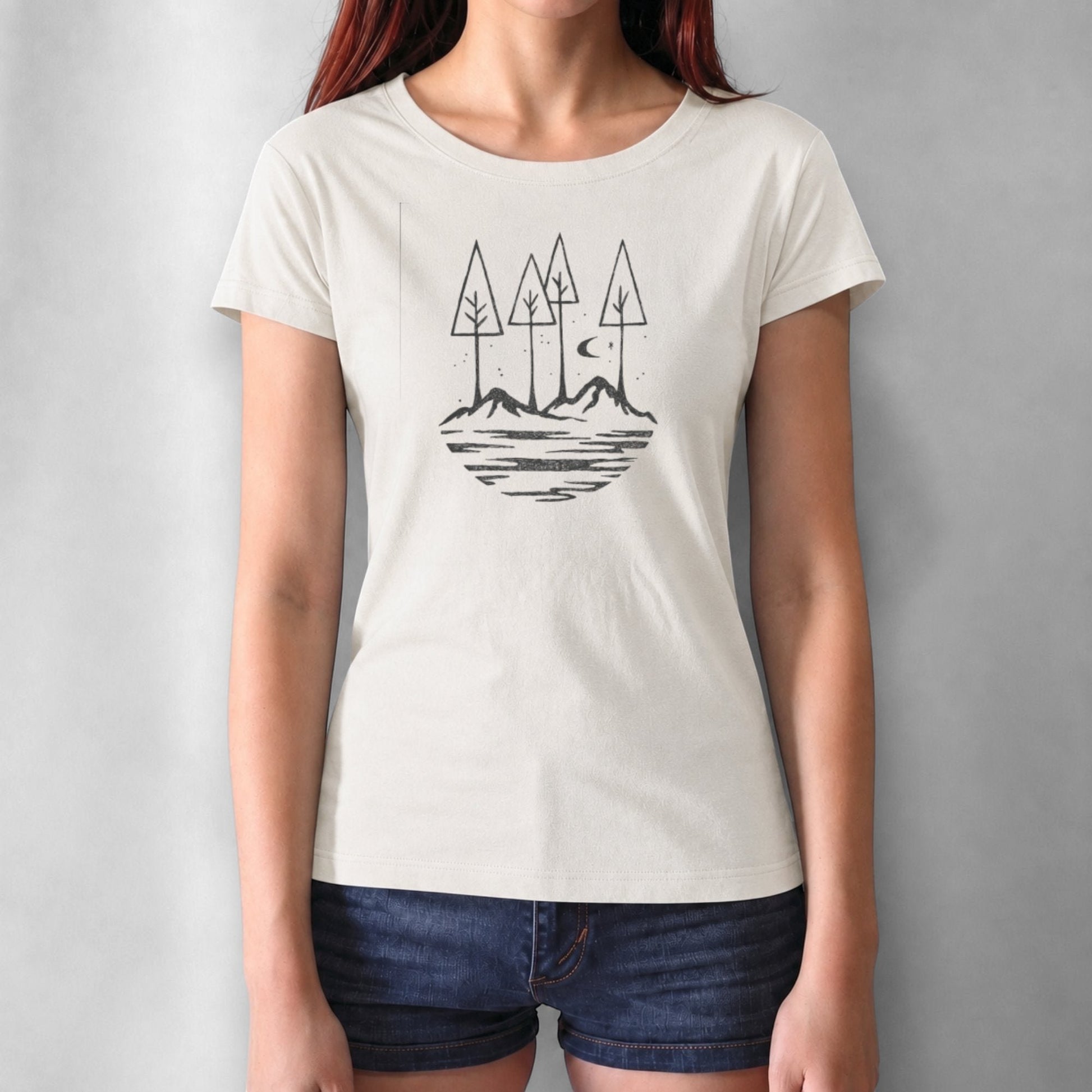 Cream-colored women's t-shirt with black forest and mountain print. Made from bamboo and organic cotton for sustainable outdoor style.