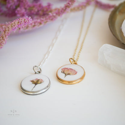 Vintage-inspired Valentine Round Rose Necklace with real rose encased in resin, available in gold and silver finishes for timeless elegance.