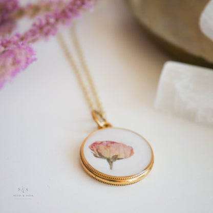 Close-up of gold Valentine Round Rose Necklace pendant showcasing a delicate dried rose, ideal for romantic and vintage jewelry lovers.