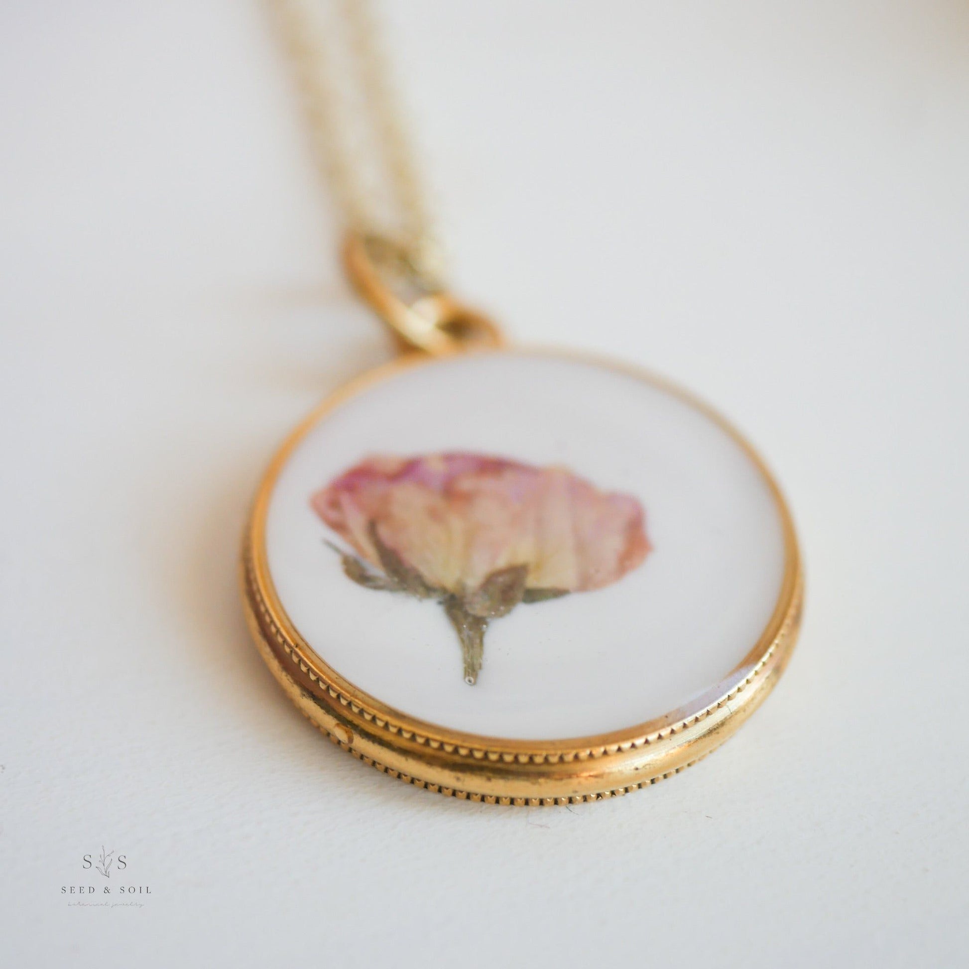 Detailed view of gold Valentine Round Rose Necklace pendant with real dried rose, emphasizing its timeless and romantic design.