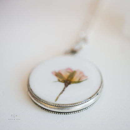 Macro shot of silver Valentine Round Rose Necklace pendant featuring a preserved rose, ideal for romantic and nature-inspired jewelry.