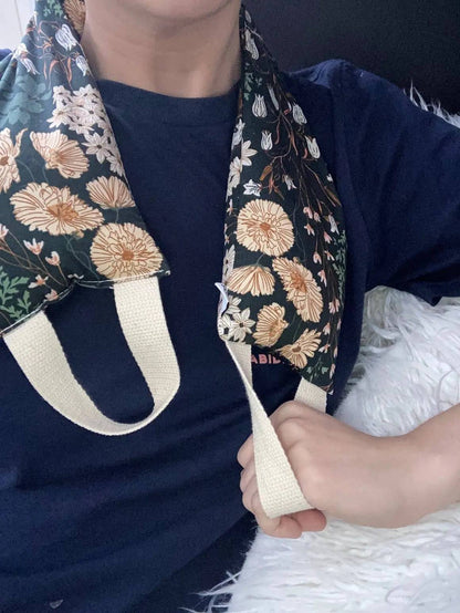 Person using floral therapy wrap on neck, demonstrating comfort and ease of use for natural pain relief with warm or cool application.