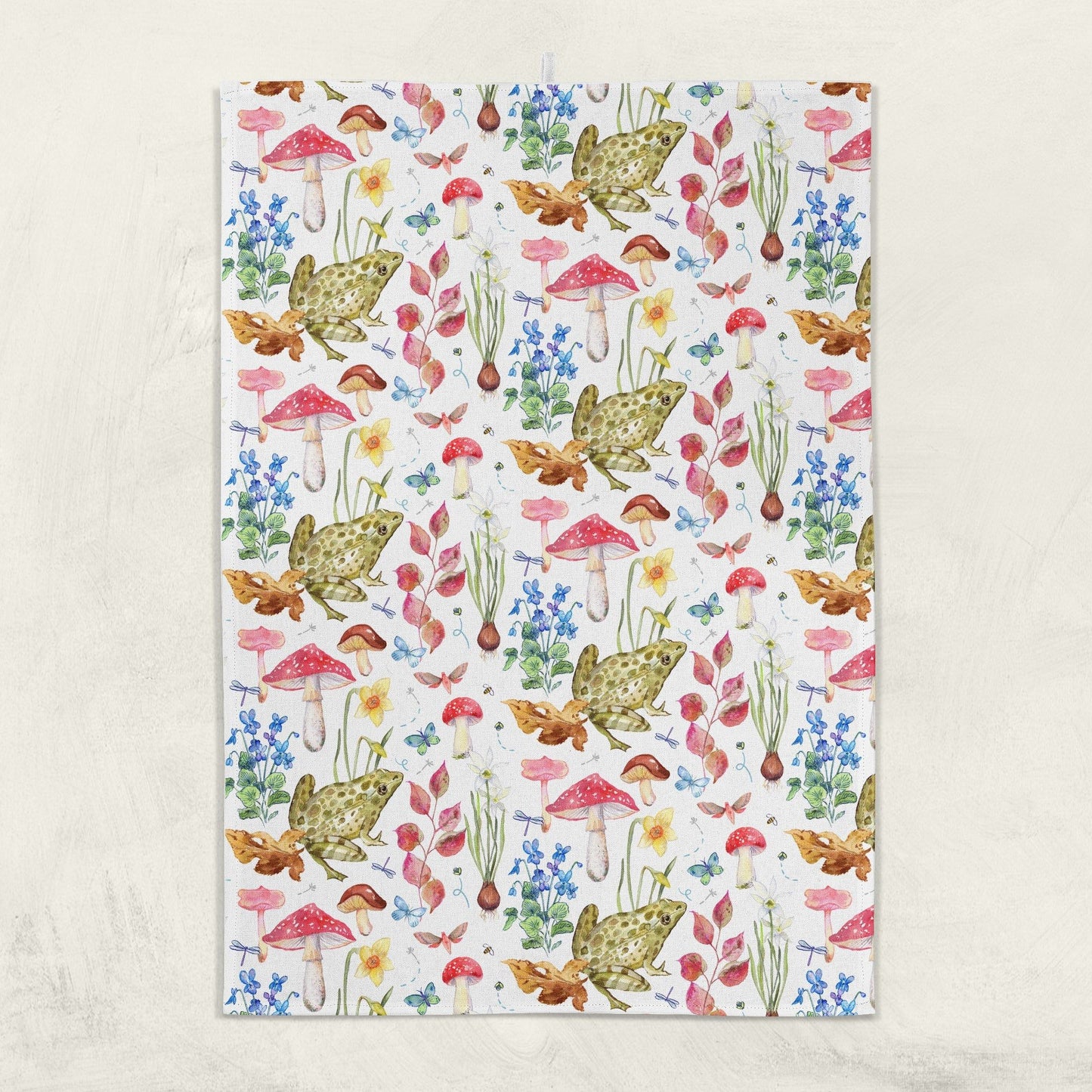 Patterned kitchen towel with frogs, mushrooms, and flowers