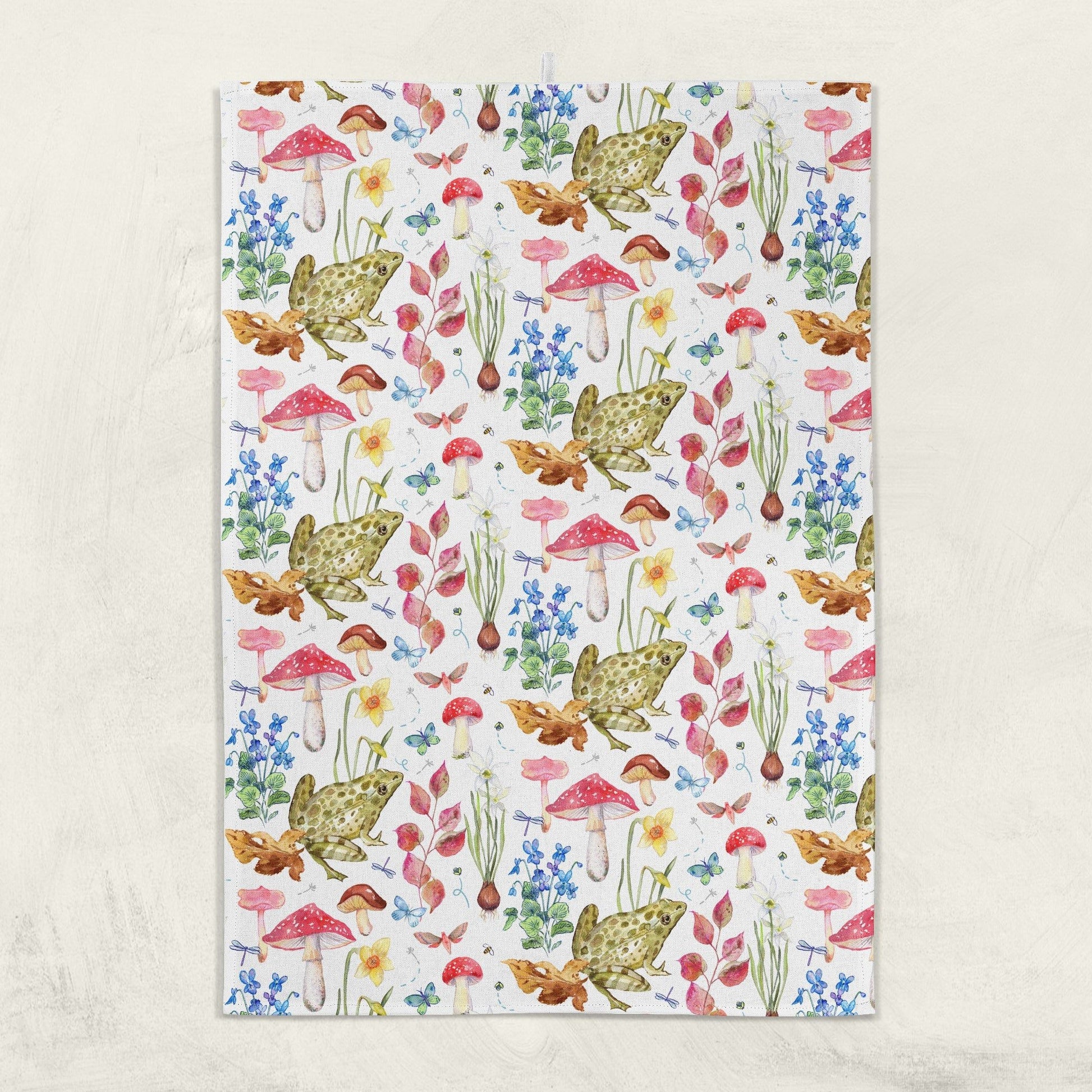 Patterned kitchen towel with frogs, mushrooms, and flowers