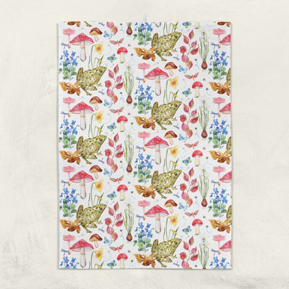 Patterned kitchen towel with frogs, mushrooms, and flowers