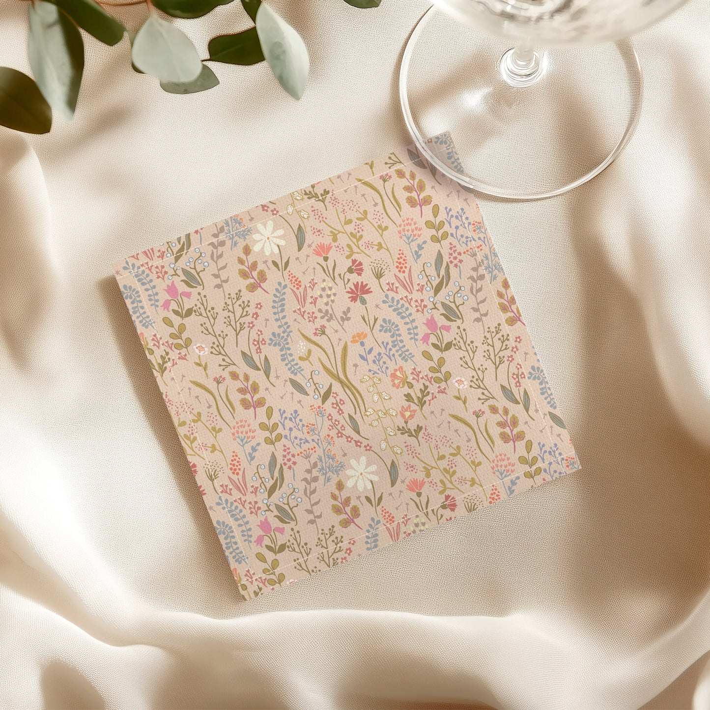 Pink floral print cloth napkin on table setting with wine glass