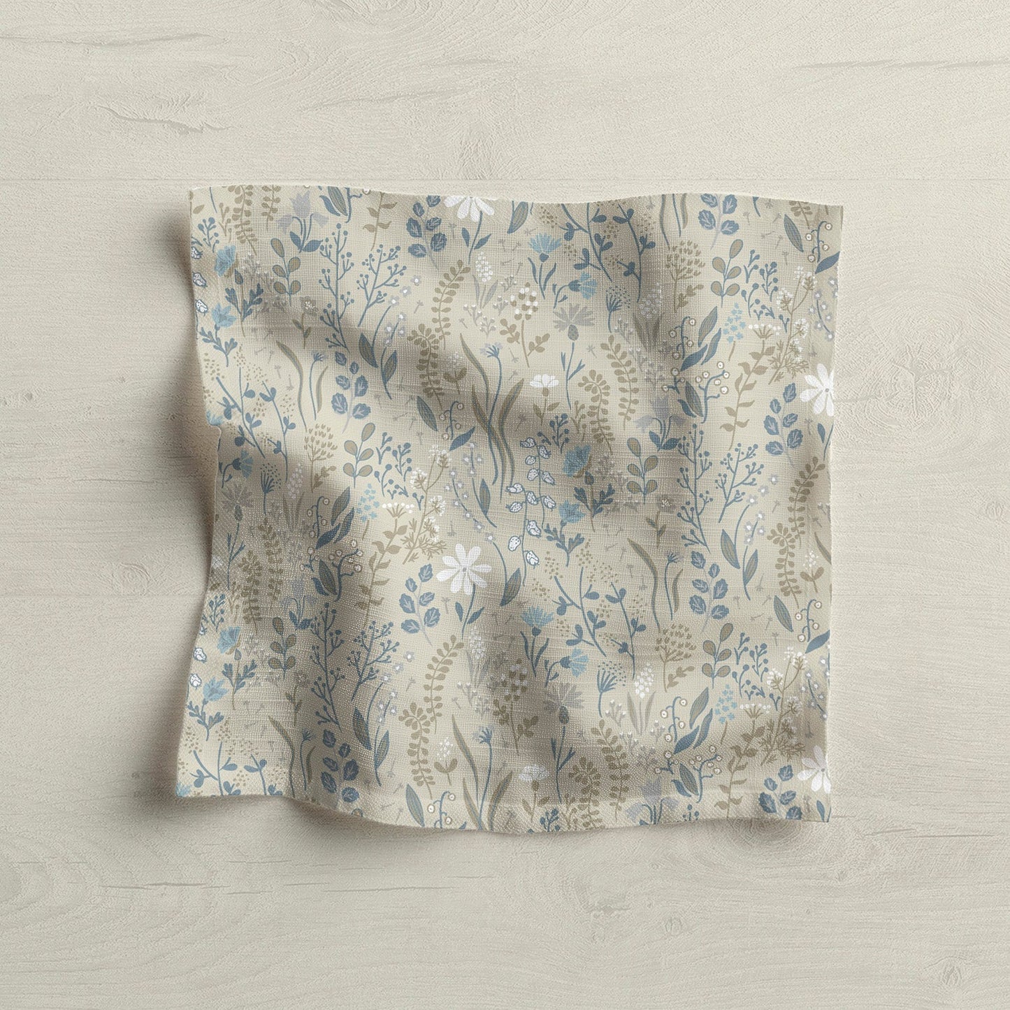 Floral patterned fabric napkin on light wood surface