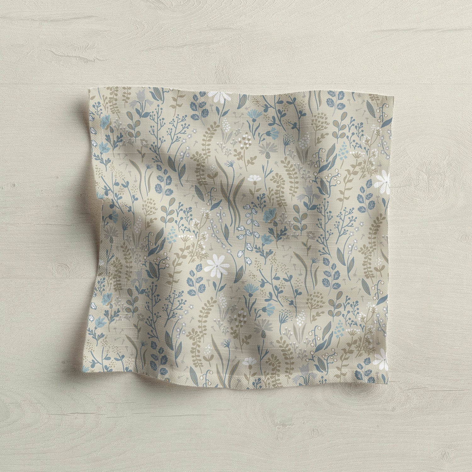 Floral patterned fabric napkin on light wood surface