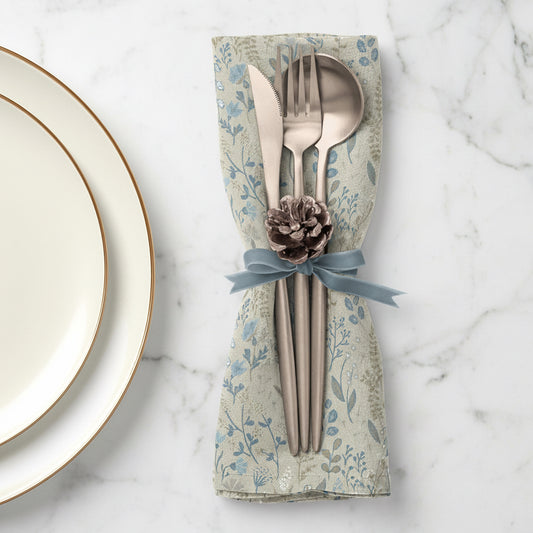 Set of floral linen napkin with cutlery and pinecone decoration