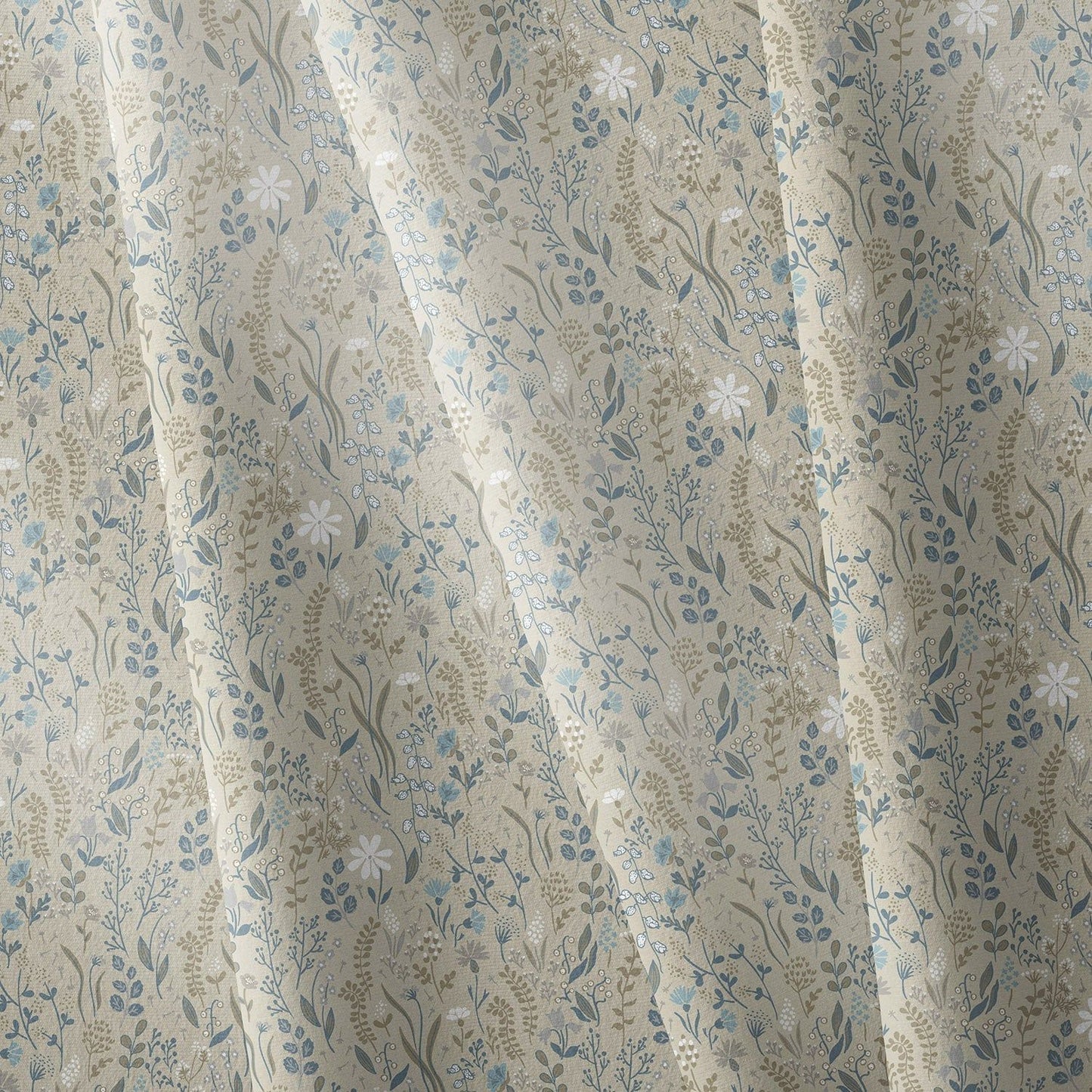 Close-up of beige floral fabric napkin with blue and white botanical print