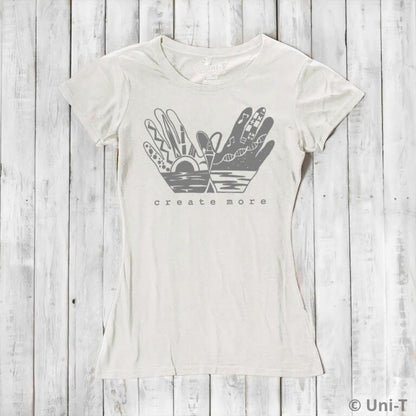 Ivory white Women's Bamboo & Organic Cotton Tee with 'Create More' artistic hands graphic. Ethical fashion top for artists and creatives.