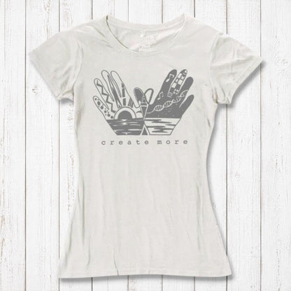 Ivory white Women's Bamboo & Organic Cotton Tee with 'Create More' artistic hands graphic. Ethical fashion top for artists and creatives.