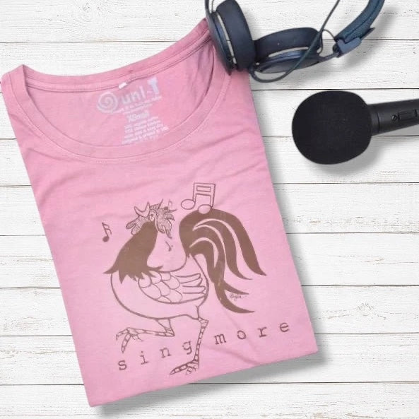 Folded pink 'Sing More' rooster t-shirt made from bamboo and organic cotton, styled with headphones and microphone for music lovers.