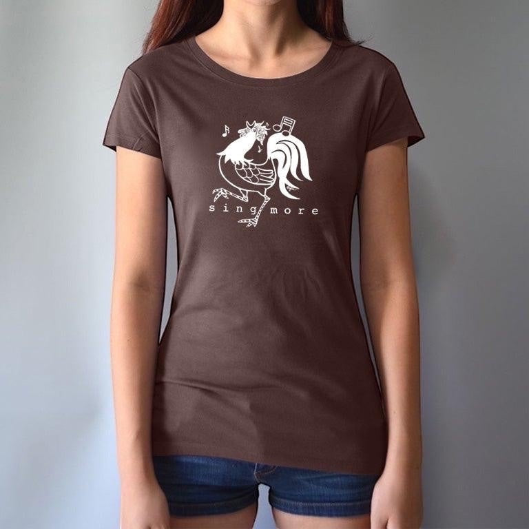 Woman wearing brown 'Sing More' rooster t-shirt made from bamboo and organic cotton, a fun and sustainable gift for music enthusiasts.