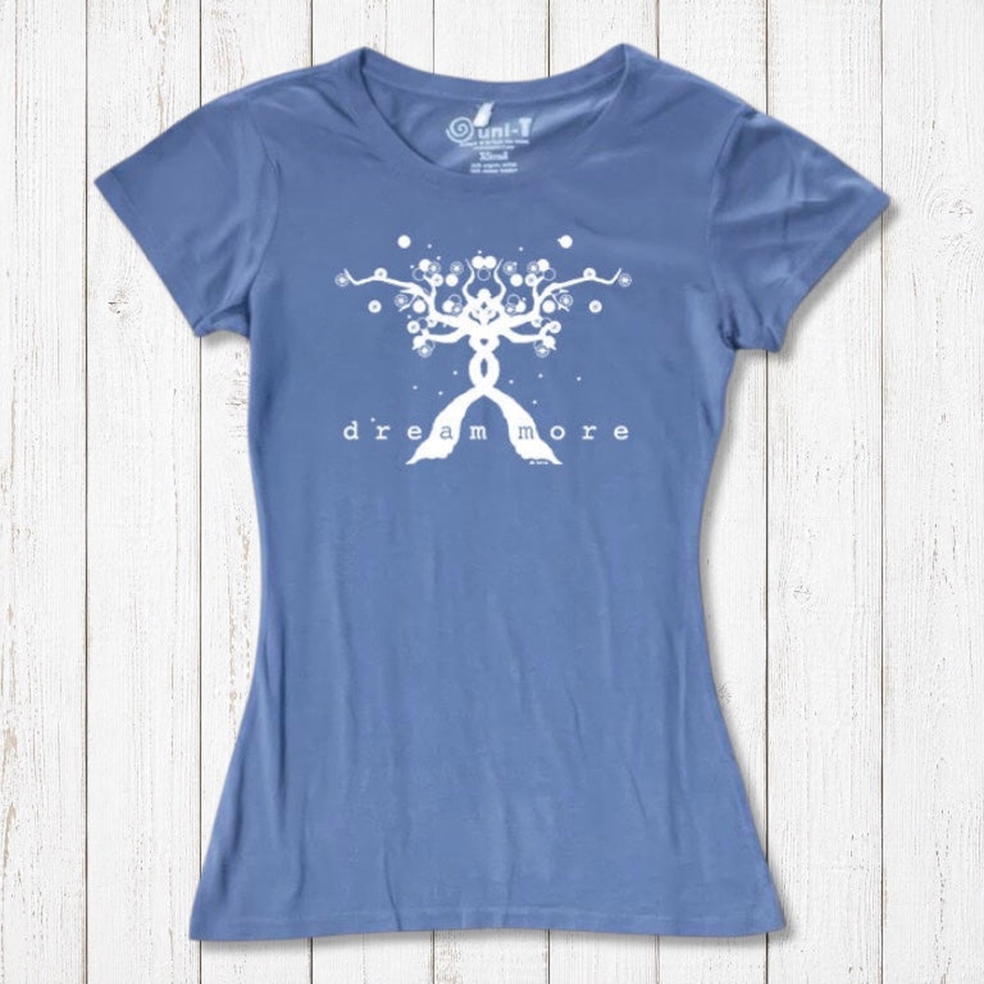Blue Women's Motivational T-Shirt in Bamboo & Organic Cotton with white 'Dream More' tree design, flat lay for inspirational apparel.