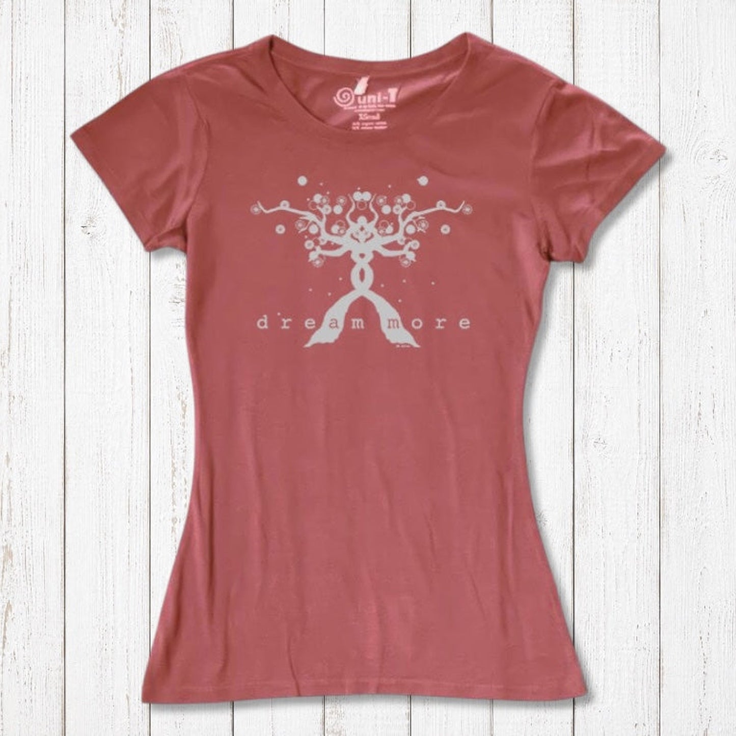 Terracotta Women's Motivational T-Shirt in Bamboo & Organic Cotton with light 'Dream More' tree design, flat lay on wood background.