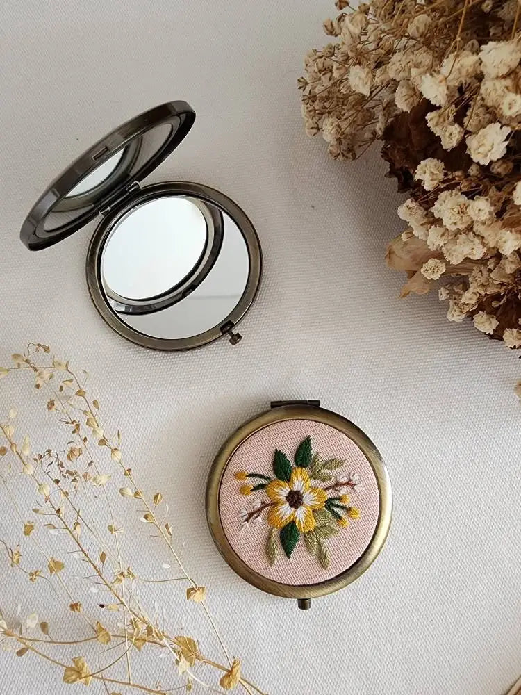 Sophia Collection compact mirror with yellow and white floral embroidery on blush background, perfect for purse or travel.