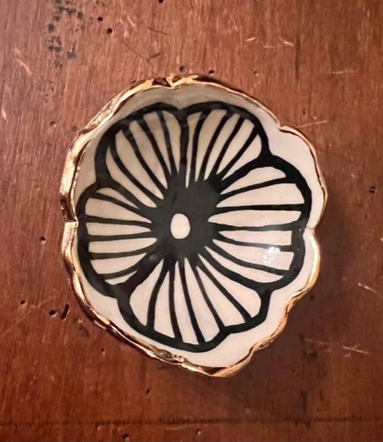 Single 3" handmade flower-shaped jewelry dish featuring a black petal design and 22K gold trim, crafted for stylish jewelry display.
