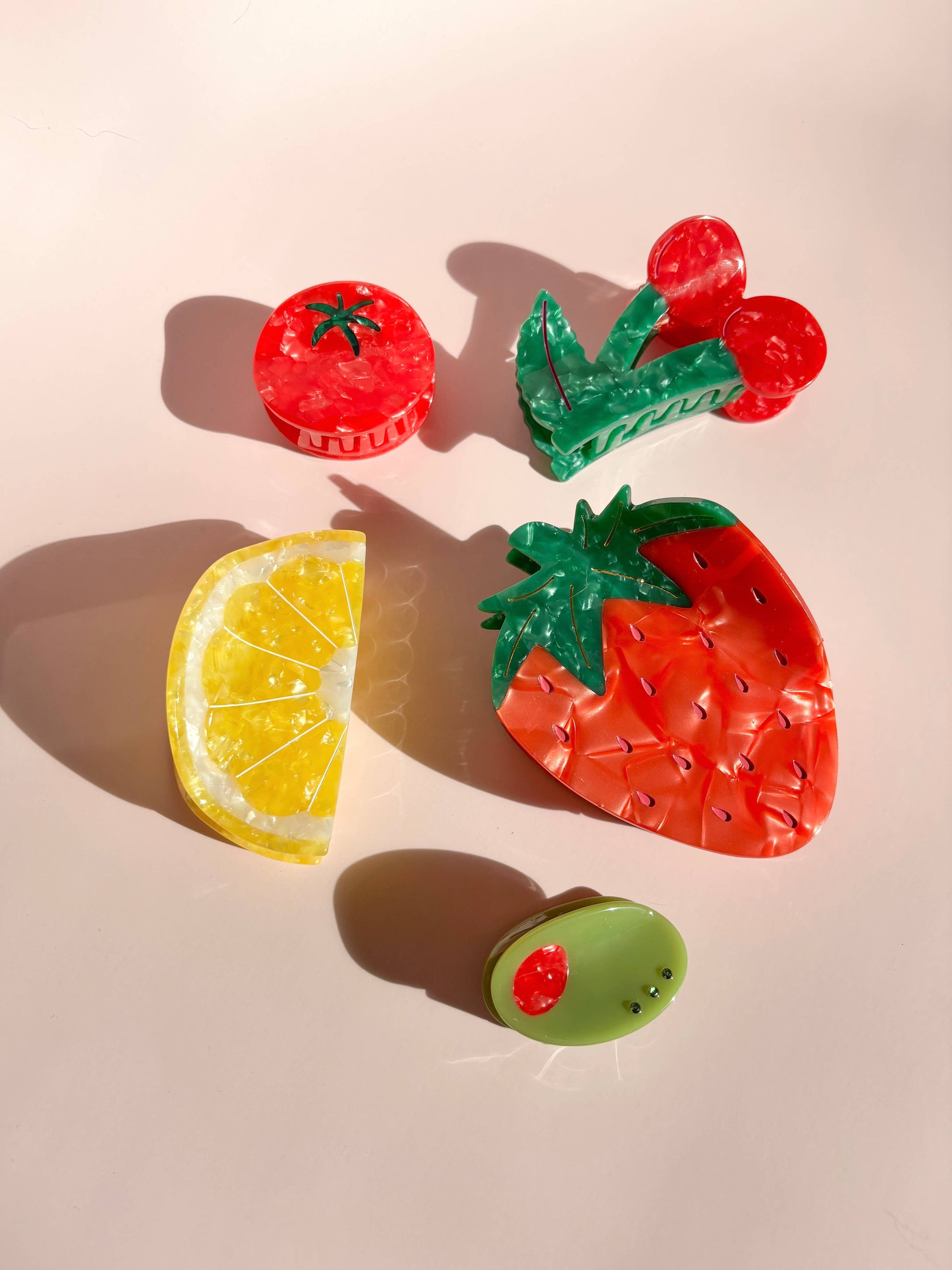 Collection of fruit-themed hair clips including the Sunshine Yellow Lemon Claw Hair Clip, ideal for playful summer accessorizing.