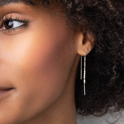 Model wearing Miyuki Thread Earring - Dark Multi Gold, highlighting its elegant drop and colorful bead accents for a chic, hypoallergenic style.