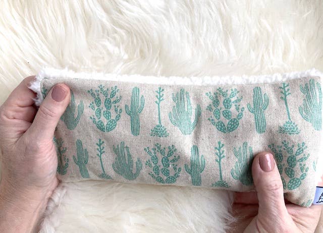 Handheld Deep Rest Eye Pillow with green cactus design, offering weighted comfort for anxiety relief and relaxation therapy.