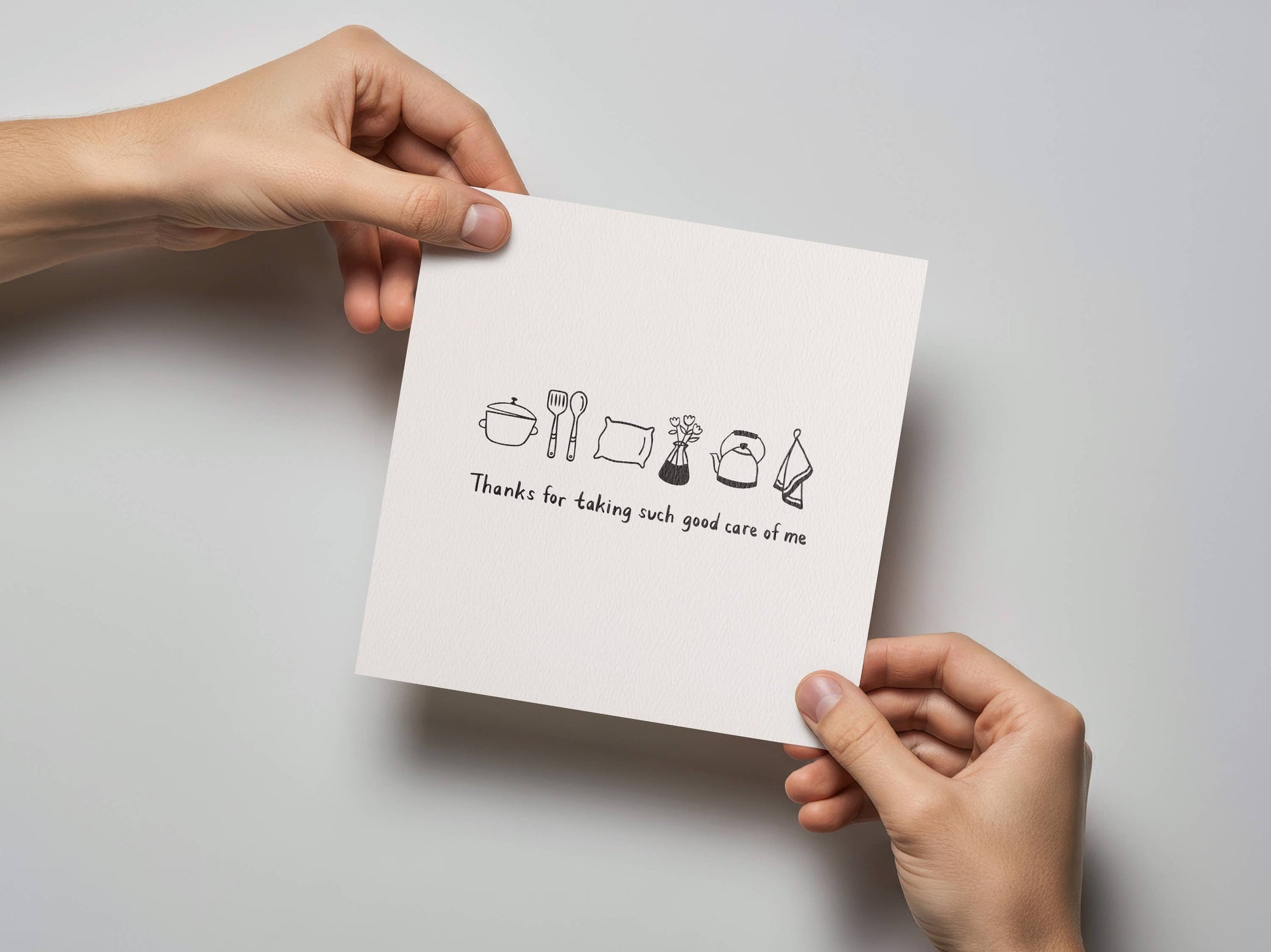 Hands holding Thanks For Taking Care of Me Thank You Card with kitchen icons
