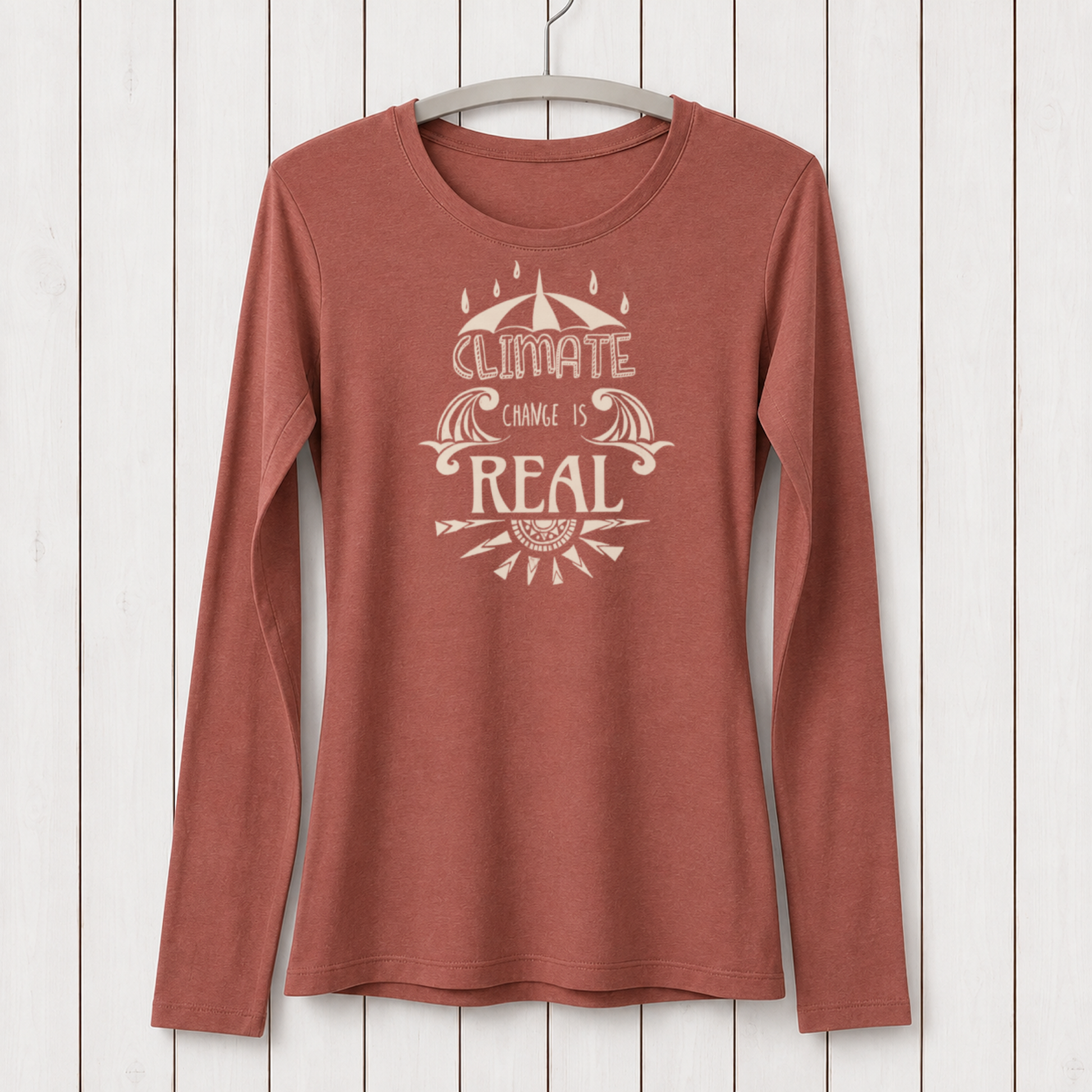 Rust-colored women's long sleeve T-shirt with eco-friendly bamboo and organic cotton material, featuring a climate change awareness graphic design, hanging on a white wooden background - SKU: WLSXSNAV