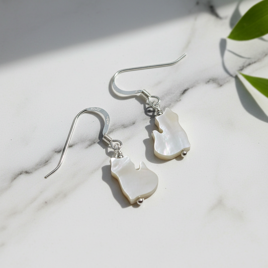 Mother of Pearl Kitty earrings on marble surface