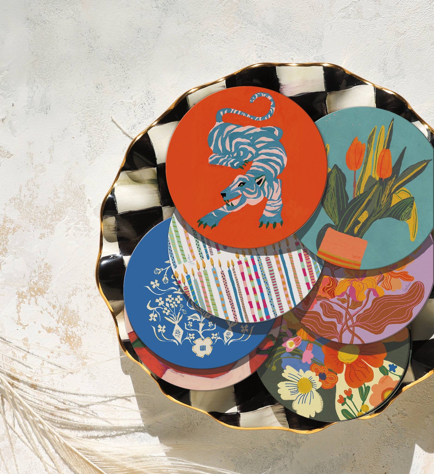 Assorted Wild Thang eco-friendly cork coasters in vibrant designs on a decorative tray, ideal for mixing and matching in home barware sets.