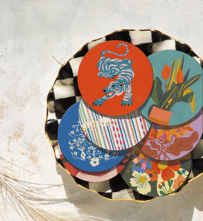 Assorted Wild Thang eco-friendly cork coasters in vibrant designs on a decorative tray, ideal for mixing and matching in home barware sets.