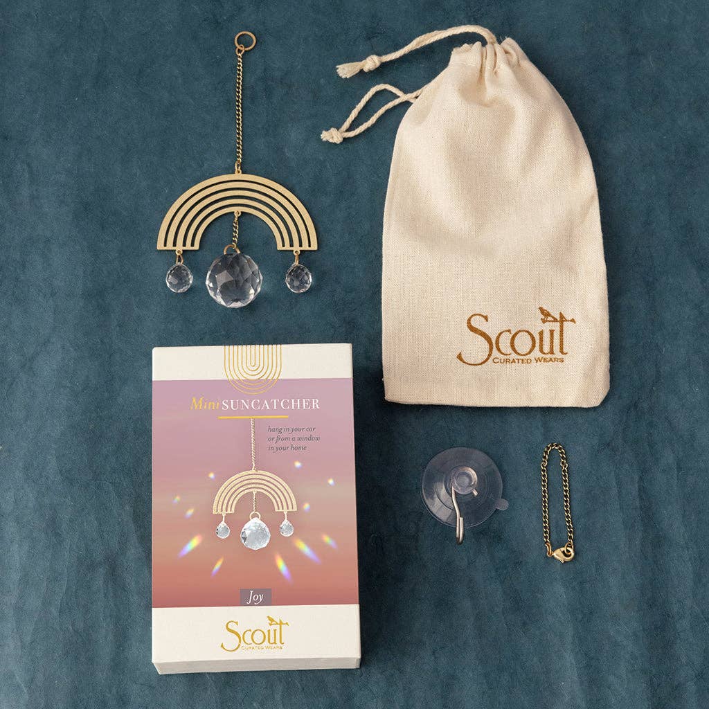 Rainbow-themed mini suncatcher gift set by Scout with brass, crystals, suction cup, and pouch. Great for window or car decor.