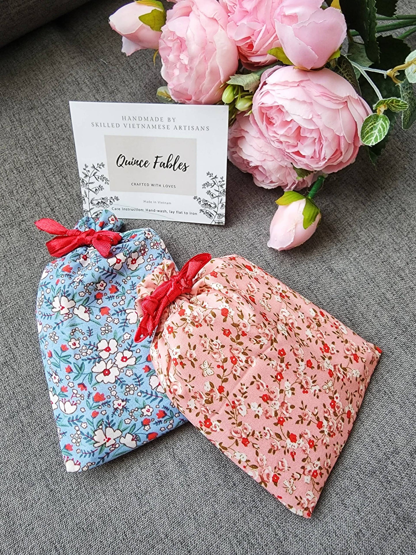 Floral pouches in pink and blue from Sophia Collection, designed to hold compact mirrors, a thoughtful and charming gift wrap option.