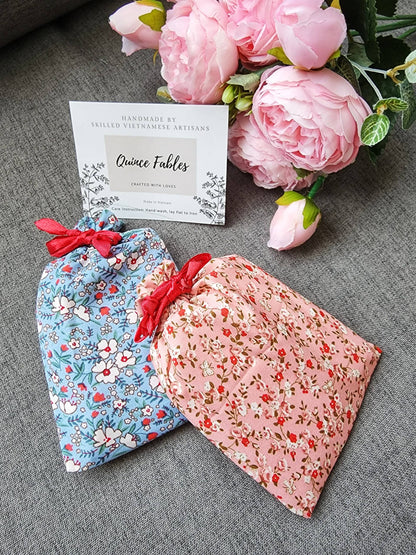 Floral pouches in pink and blue from Sophia Collection, designed to hold compact mirrors, a thoughtful and charming gift wrap option.