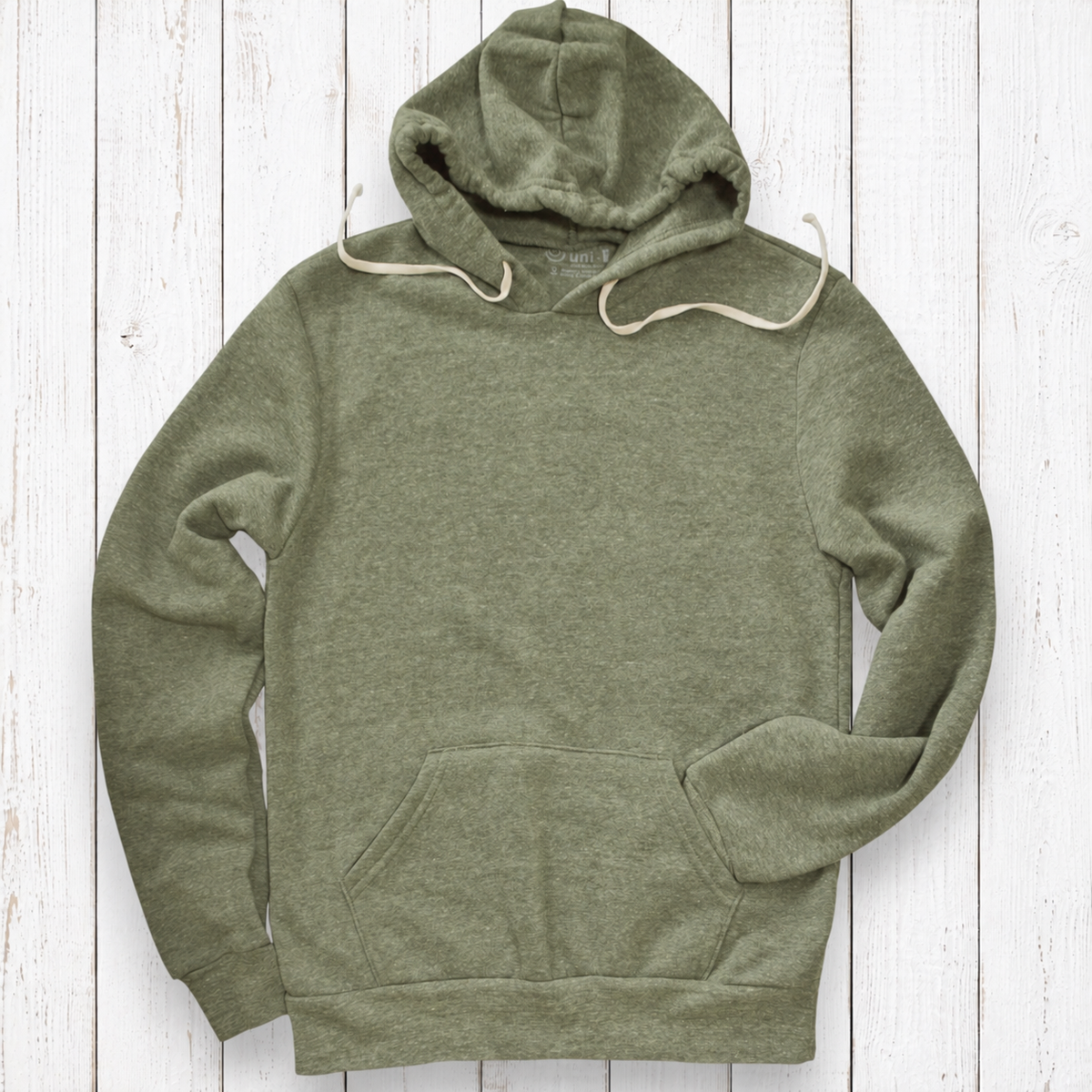 Heather olive hoodie on white wood.png