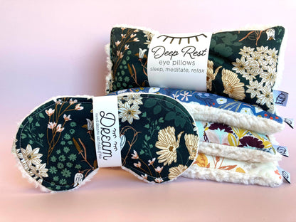 Stack of Emerald Sleep Masks and Deep Rest eye pillows in floral prints, perfect for meditation, sleep, and relaxation routines.