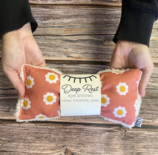 Hands holding Deep Rest Eye Pillow - Relaxation & Sleep Aid in floral daisy design, perfect for calming acupressure and self-care use.