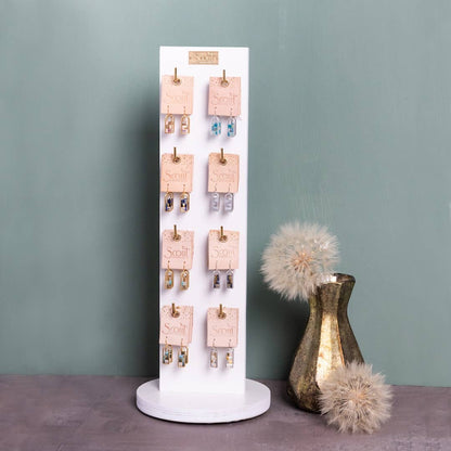 Retail display stand featuring Miyuki Frame Earrings - Indigo/Gold among other color variants, ideal for boutique jewelry presentation.