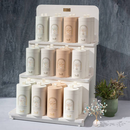 Retail display of Suncatcher Tree of Life - Turquoise Crystals in assorted packaging colors, with one suncatcher placed in front.