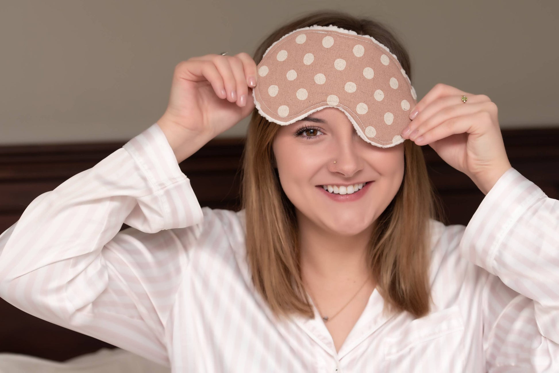 Model wearing Sweet Dreams Sleep Mask in polka dot design, demonstrating fit and comfort, ideal for promoting sleep accessories in loungewear context.