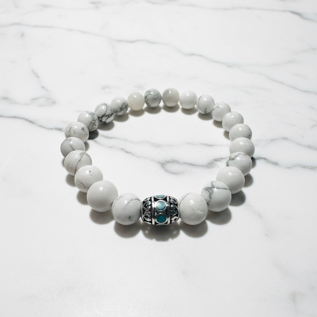 White gemstone beaded stretch bracelet with decorative silver and turquoise bead