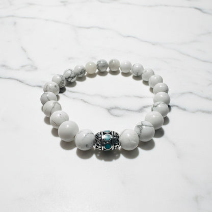White gemstone beaded stretch bracelet with decorative silver and turquoise bead