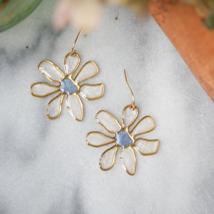 Blue-centered daisy stained glass earrings with delicate gold framing. Ideal for summer fashion, limited edition jewelry.