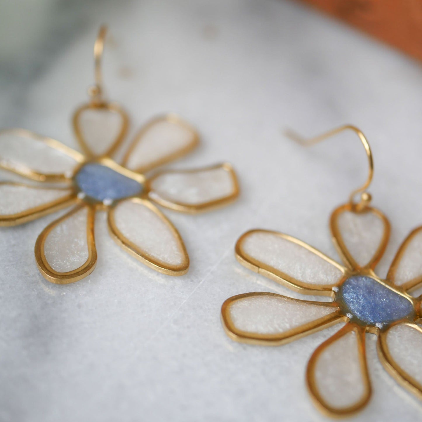 Blue daisy stained glass earrings with shimmering petals and gold outline. Elegant summer jewelry, available at Seed&SoilShop.