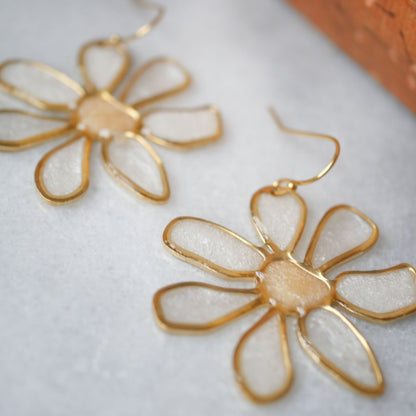 Detailed view of peach daisy stained glass earrings showing translucent petals and gold edges. Perfect summer accessory, shop now.