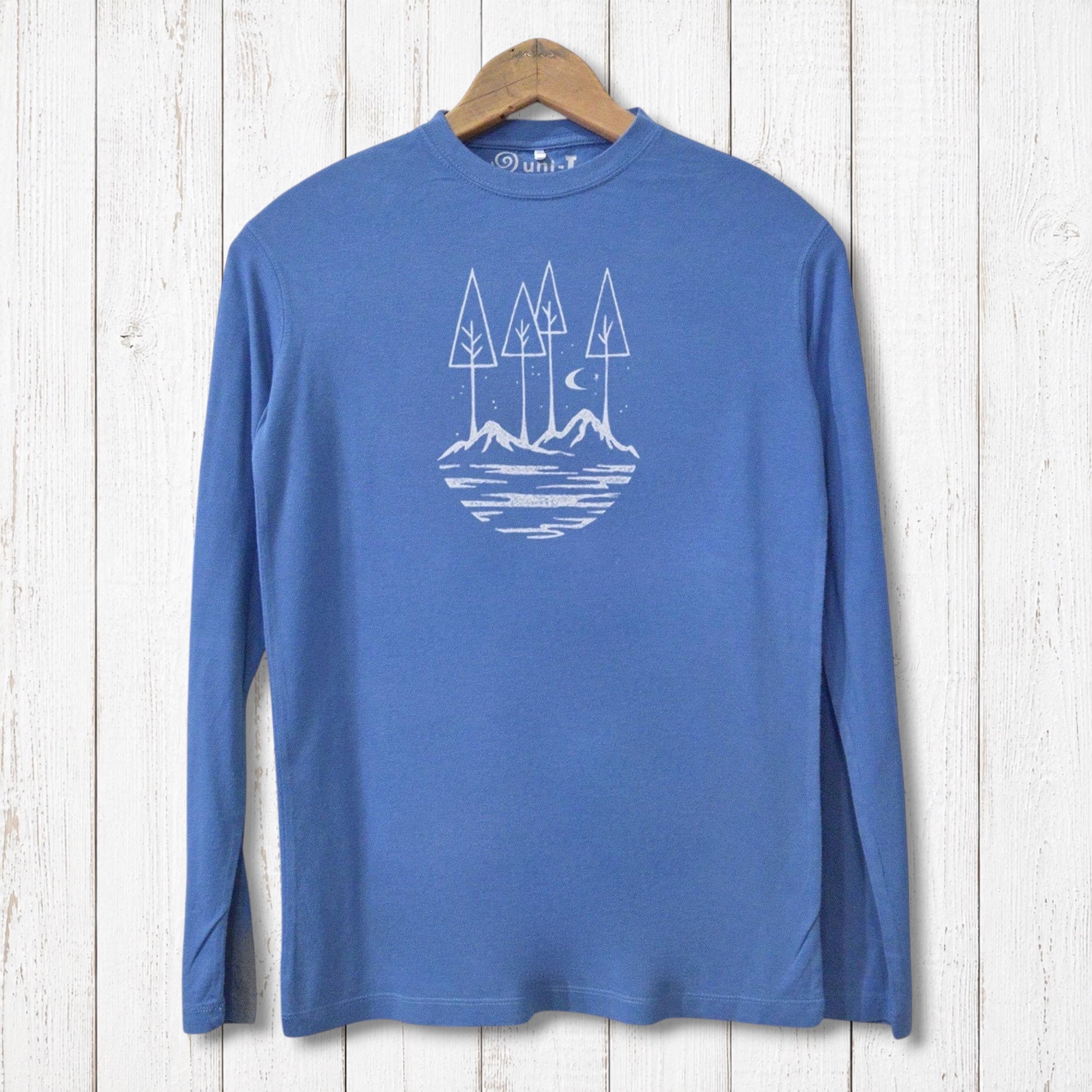 Uni-T blue long sleeve bamboo t-shirt featuring a white nature-inspired mountain and tree graphic on a wooden background