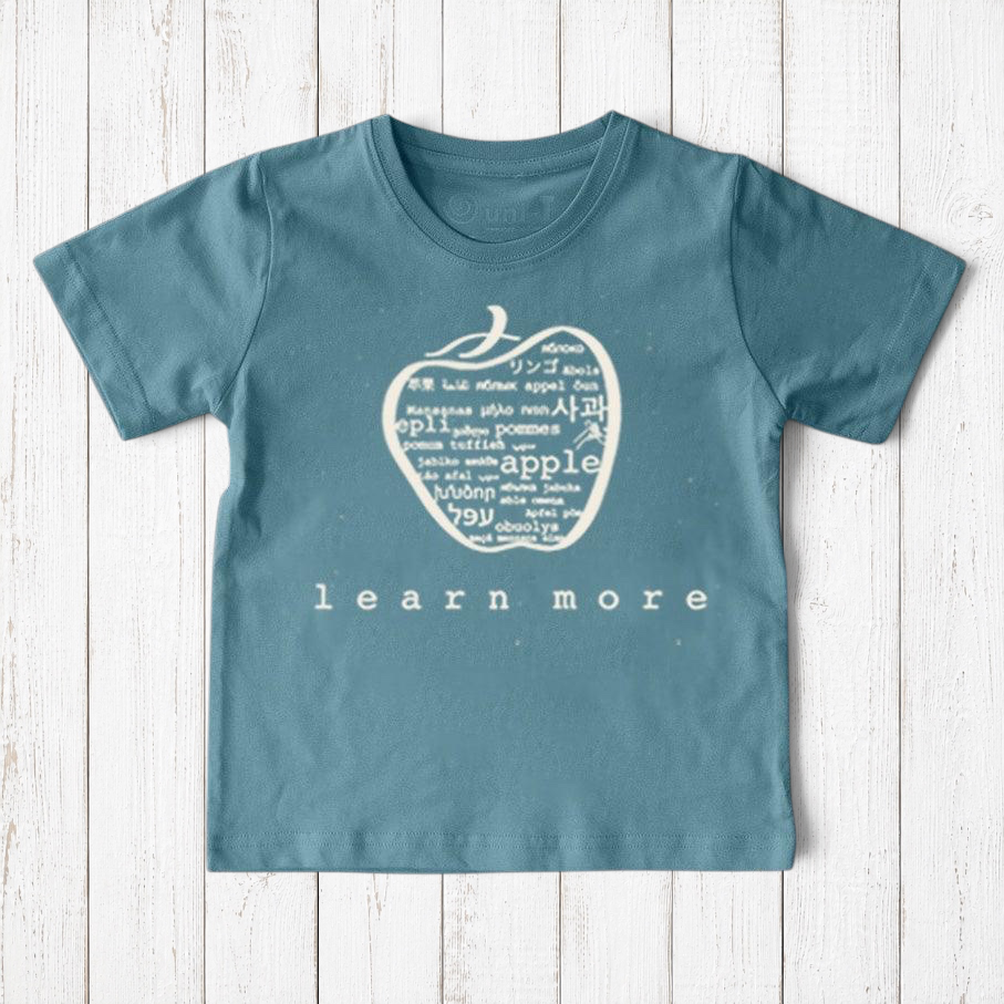 Uni-T kids organic cotton t-shirt in blue with a white hand-illustrated apple graphic featuring global languages